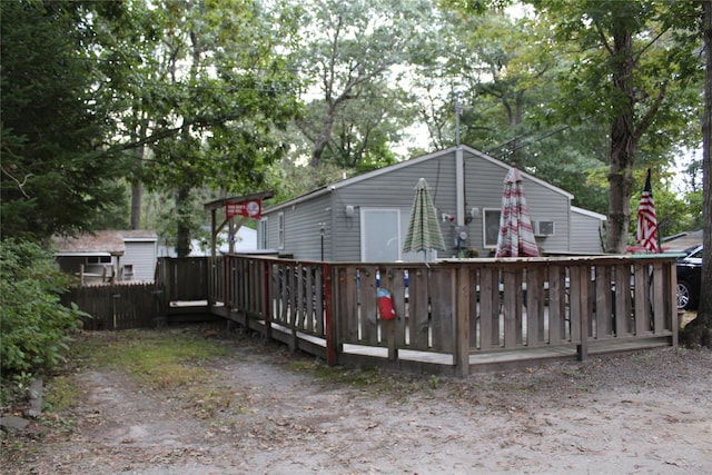 rear view of house featuring a wooden deck