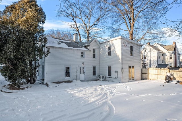 view of snow covered rear of property