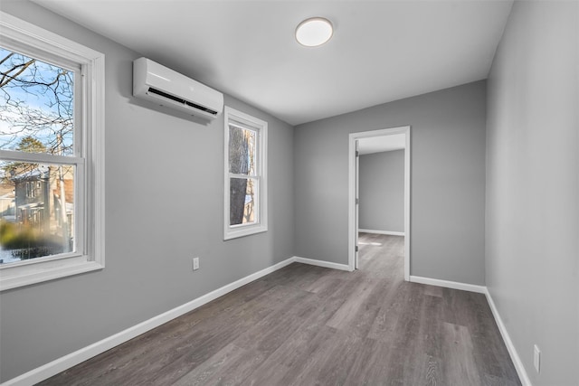 empty room with hardwood / wood-style flooring and a wall mounted AC