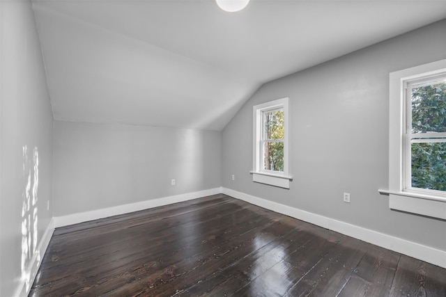 bonus room with hardwood / wood-style floors and vaulted ceiling