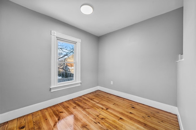 spare room featuring wood-type flooring