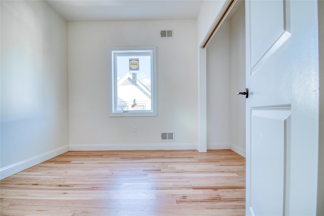 empty room with light hardwood / wood-style flooring