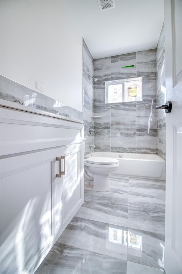 full bathroom featuring shower / tub combination, vanity, and toilet