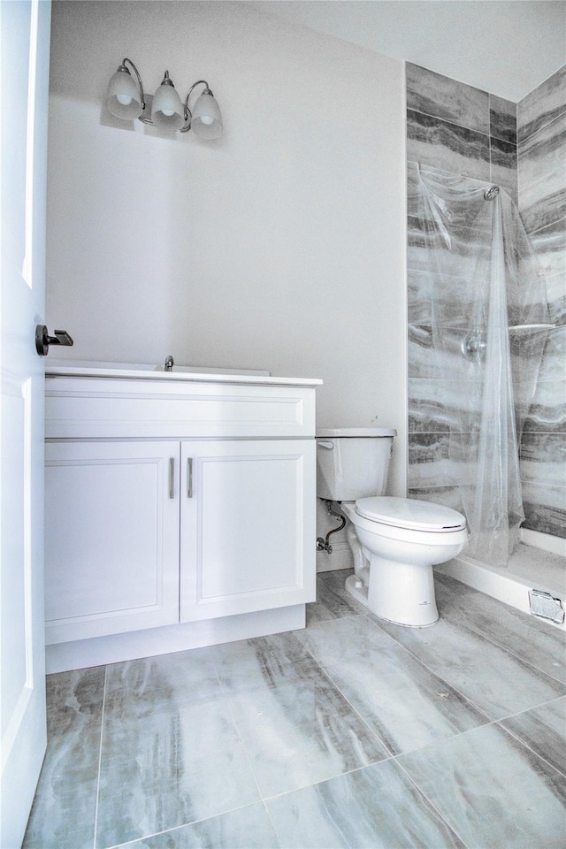 bathroom featuring vanity, toilet, and a shower