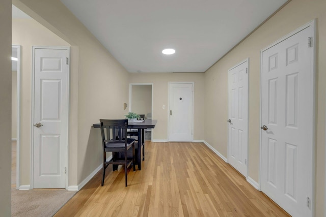 corridor with light hardwood / wood-style flooring