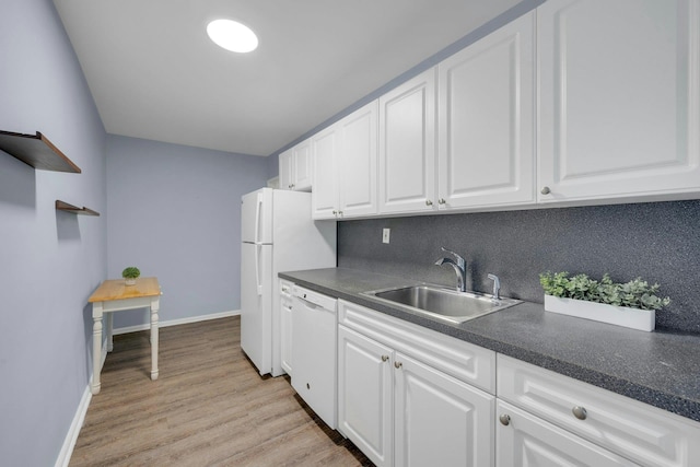 kitchen featuring white appliances, sink, decorative backsplash, and white cabinets