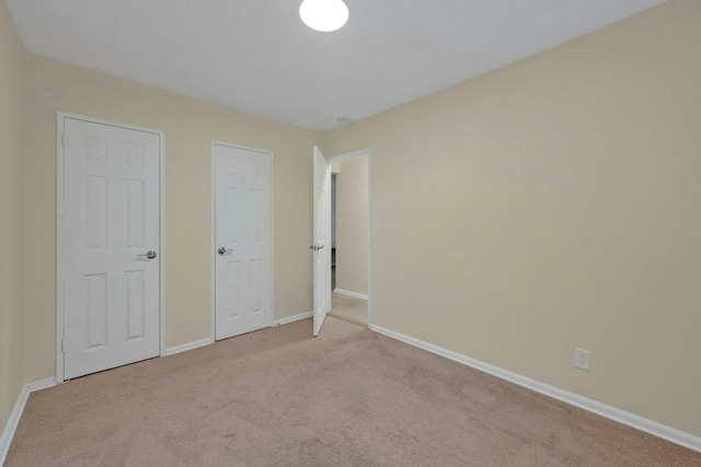 unfurnished bedroom with light carpet