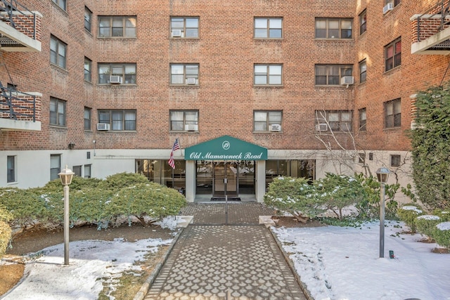 snow covered property featuring cooling unit