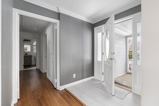 foyer entrance with crown molding and dark hardwood / wood-style flooring