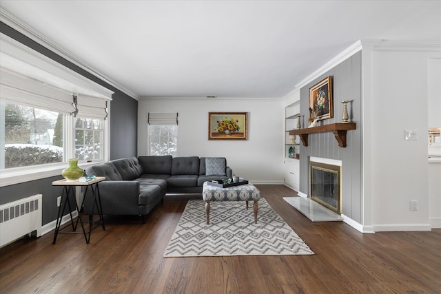 living room with radiator heating unit, ornamental molding, and dark hardwood / wood-style floors