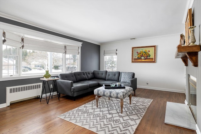 living room with ornamental molding, radiator, and hardwood / wood-style floors