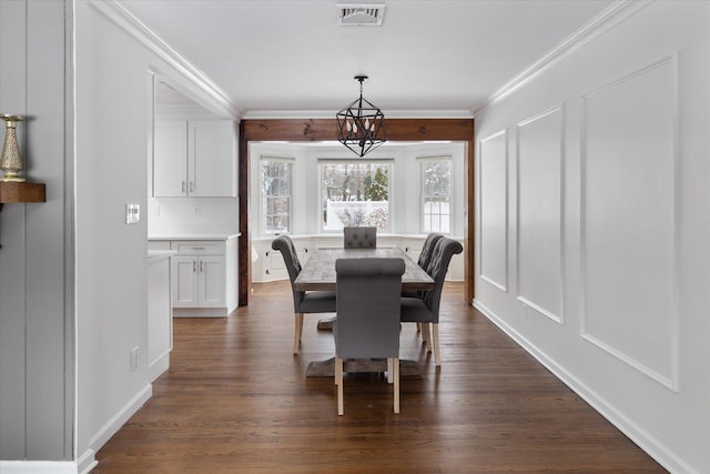 dining space featuring crown molding, a notable chandelier, and dark hardwood / wood-style flooring