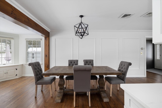 dining space with ornamental molding, dark hardwood / wood-style floors, and an inviting chandelier