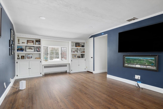 unfurnished living room featuring hardwood / wood-style floors, radiator heating unit, and built in features