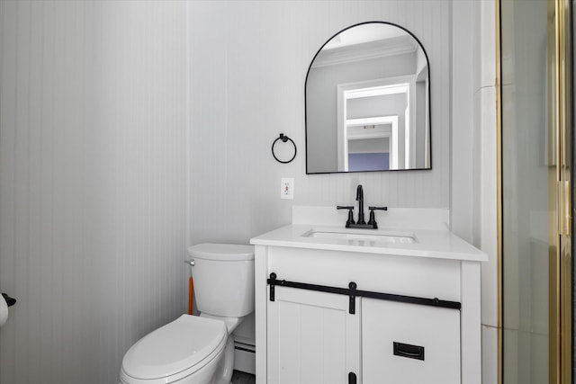 bathroom featuring vanity, toilet, and a baseboard heating unit