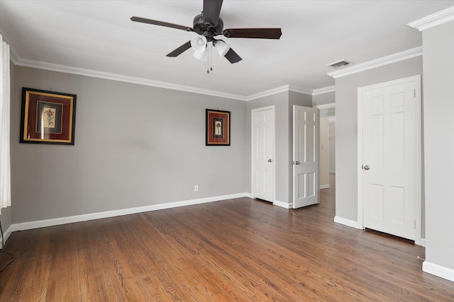 unfurnished bedroom featuring ornamental molding and dark hardwood / wood-style floors