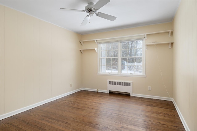 unfurnished room featuring dark hardwood / wood-style flooring, radiator heating unit, and ceiling fan