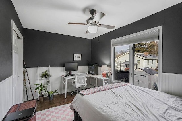 bedroom with dark wood-type flooring, ceiling fan, and access to exterior