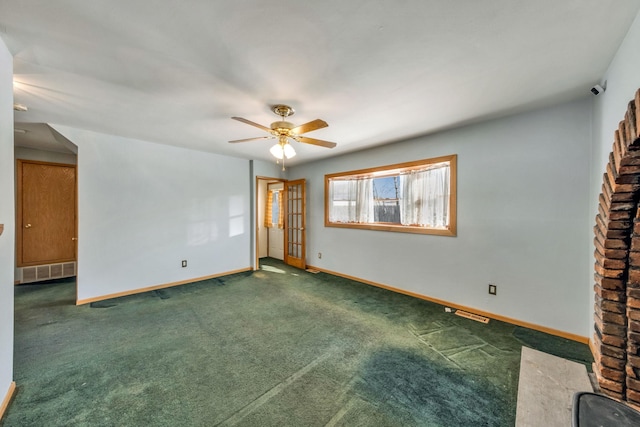 empty room with dark colored carpet and ceiling fan