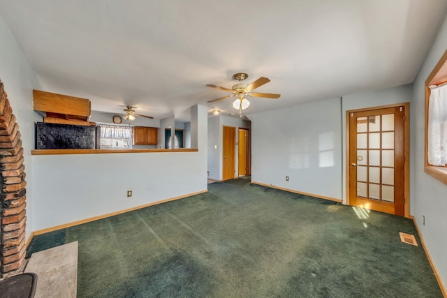 unfurnished living room featuring dark colored carpet and ceiling fan