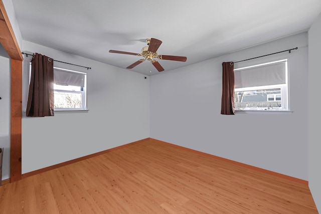 empty room featuring ceiling fan and light hardwood / wood-style floors