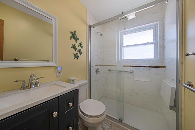 bathroom featuring vanity, toilet, tile patterned flooring, and a shower with door