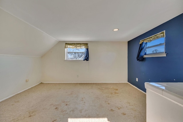 bonus room with lofted ceiling and carpet