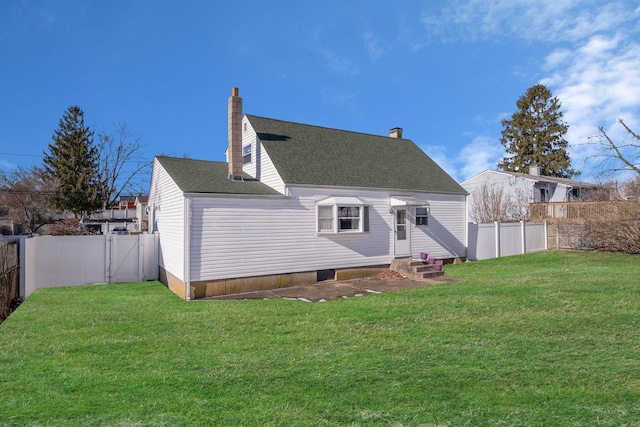 rear view of property featuring a yard