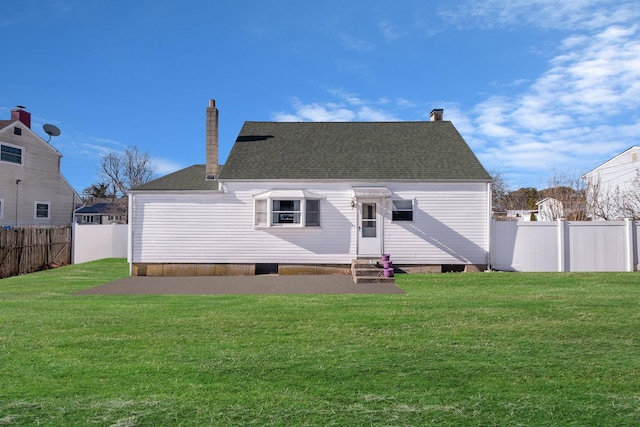 rear view of house featuring a lawn