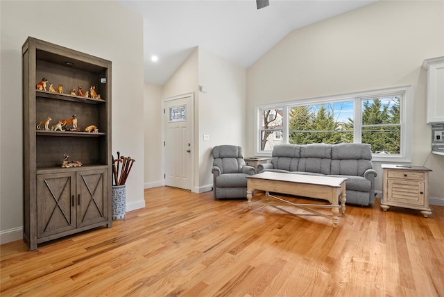 sitting room with vaulted ceiling and light hardwood / wood-style flooring