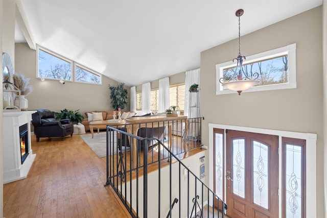 foyer featuring lofted ceiling and light hardwood / wood-style flooring