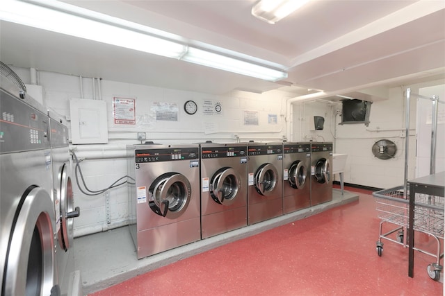 washroom with washing machine and clothes dryer and electric panel