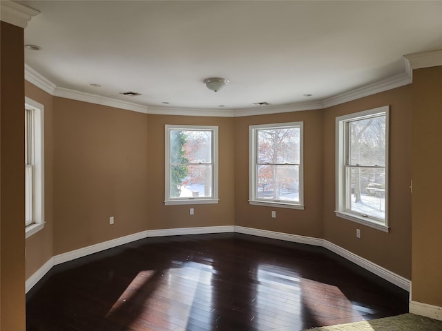 empty room featuring ornamental molding and dark hardwood / wood-style flooring