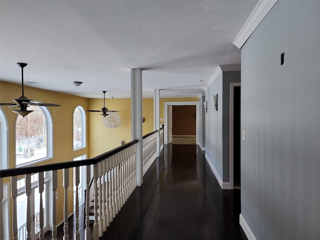 corridor with dark wood-type flooring and ornamental molding