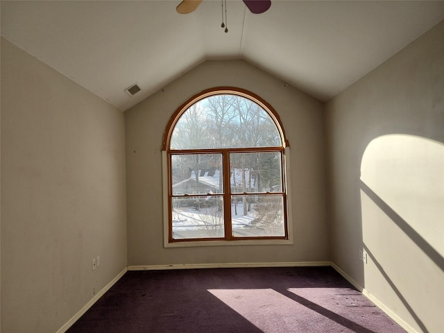 carpeted spare room featuring ceiling fan and lofted ceiling