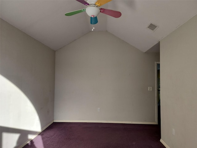 unfurnished room featuring lofted ceiling, dark carpet, and ceiling fan