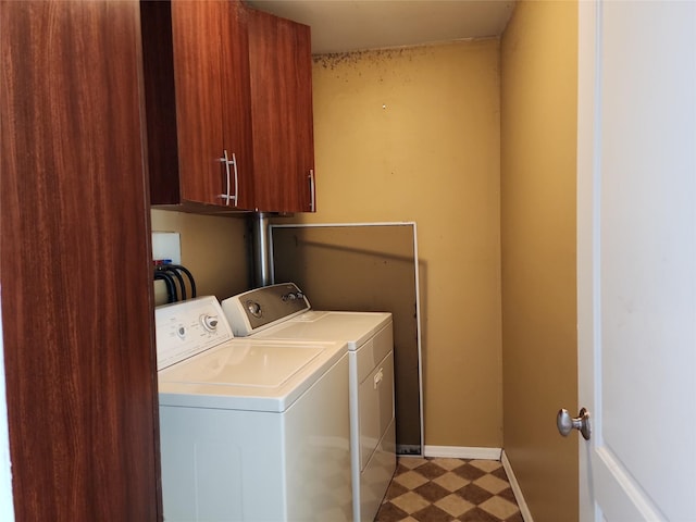 washroom featuring cabinets and washer and dryer