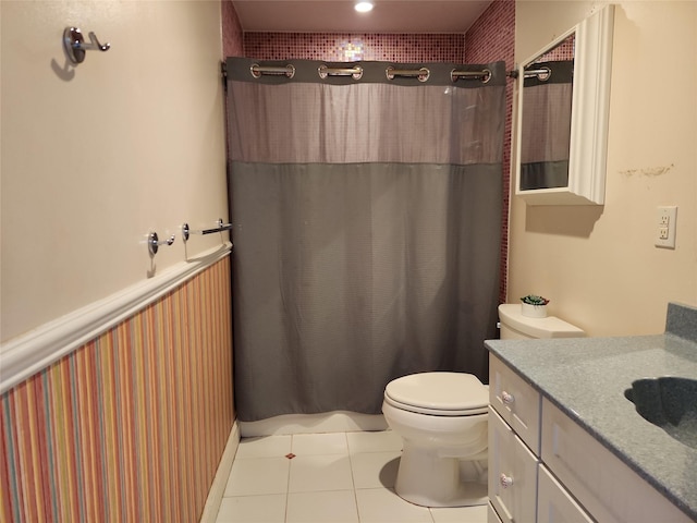 bathroom featuring tile patterned floors, toilet, and vanity