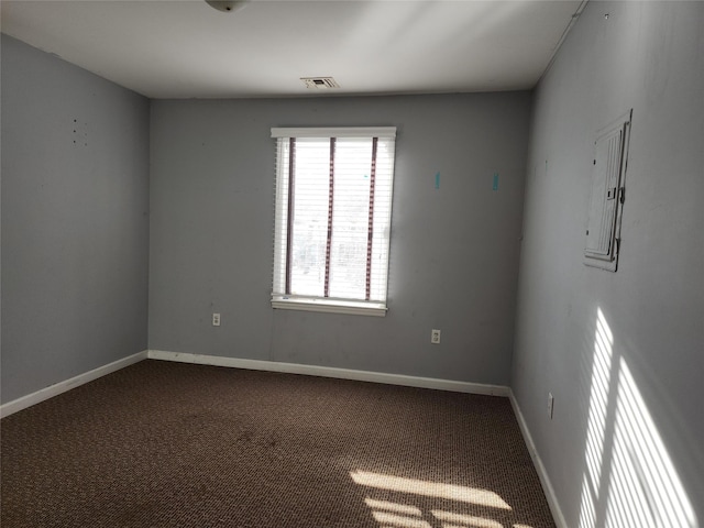 empty room with electric panel and carpet floors