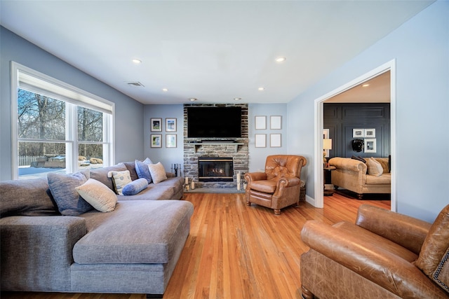 living room with wood-type flooring and a fireplace