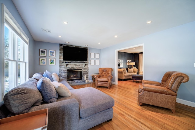 living room with a fireplace and light hardwood / wood-style flooring