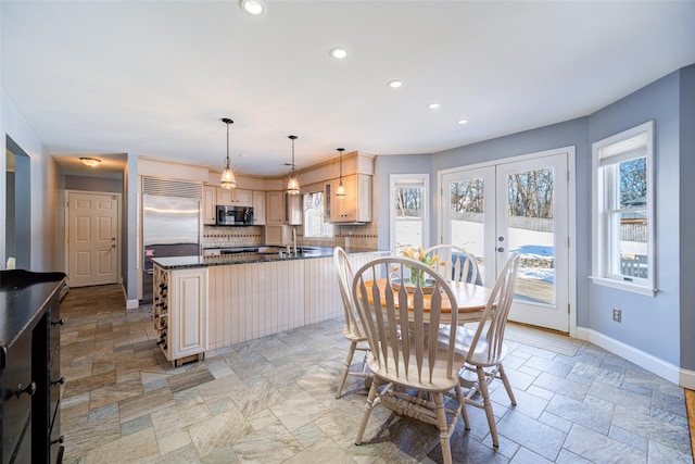 dining area with sink and french doors