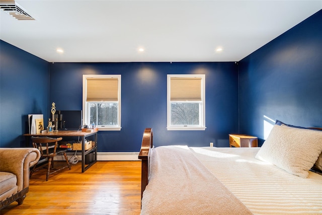 bedroom featuring a baseboard radiator and light wood-type flooring