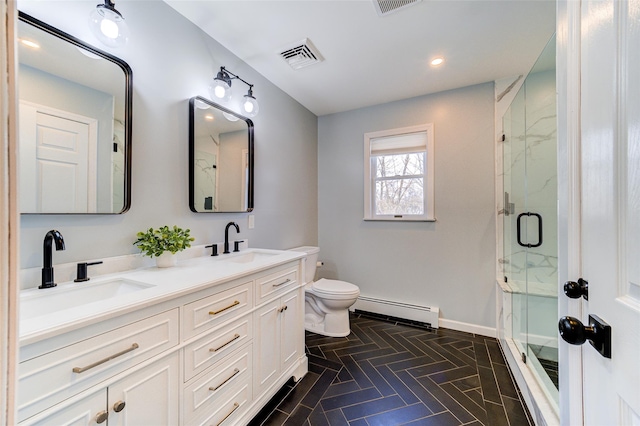 bathroom with a baseboard radiator, toilet, vanity, and a shower with shower door