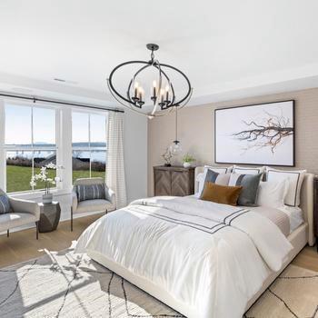 bedroom featuring light hardwood / wood-style flooring, a chandelier, and a water view