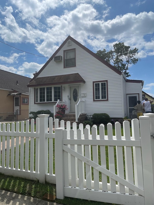 view of front of home featuring an AC wall unit