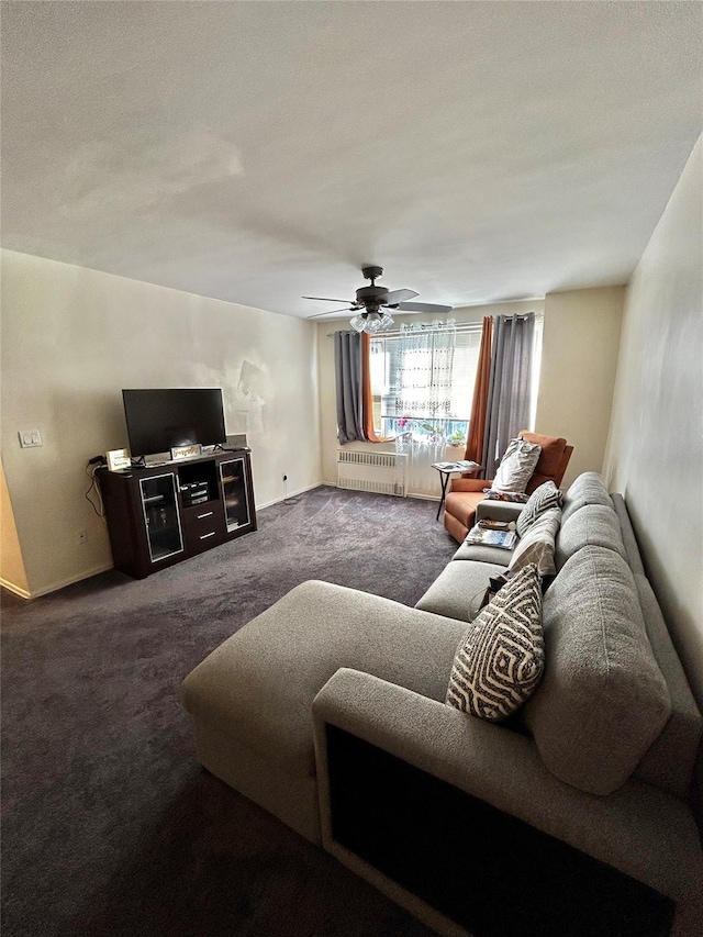 living room featuring radiator, ceiling fan, and dark colored carpet