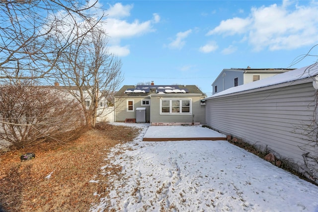 view of snow covered back of property