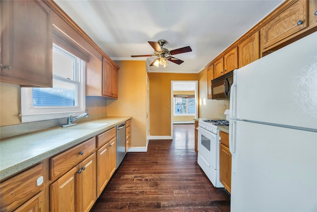 kitchen featuring sink, white appliances, crown molding, ceiling fan, and dark hardwood / wood-style flooring