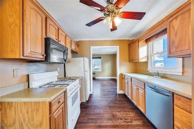 kitchen with ceiling fan, white appliances, dark hardwood / wood-style floors, and sink